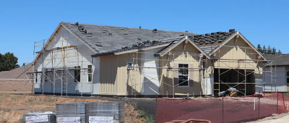 A new single-story home with scaffolding along its front